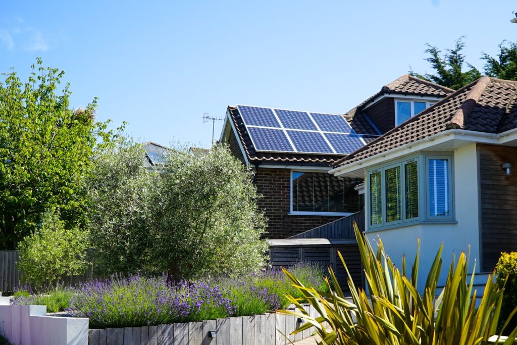 Solar panels in the midday sun on a house roof